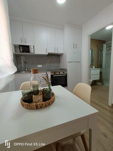 a kitchen with a table with a bowl of flowers on it at As Mimosas d'Cross in Redondela