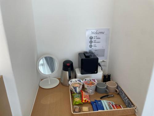a kitchen counter with a tray of food and a microwave at Kenting Onehome in Checheng