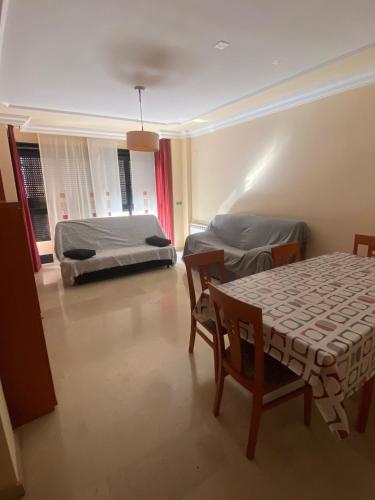 a bedroom with a bed and a table and chairs at Casa Flare Apartmento para 6 personas en Cheste in Cheste