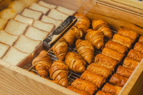 a tray of pastries and croissants on a rack at Hotel La'gent Plaza Hakodate Hokuto in Hokuto