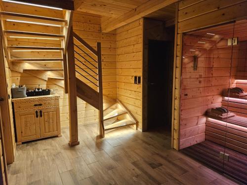 a room with a staircase in a wooden cabin at Velo Active & Spa in Frydman