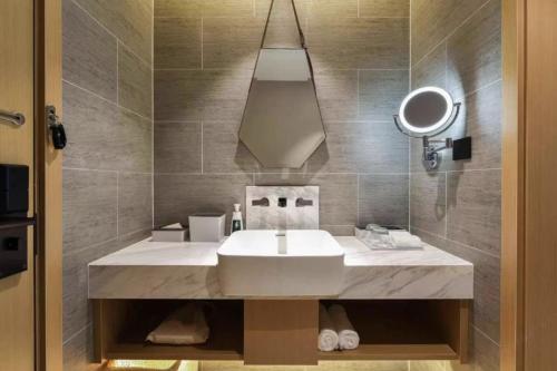 a bathroom with a sink and a mirror at Atour Hotel Beijing Chaoyangmen in Beijing