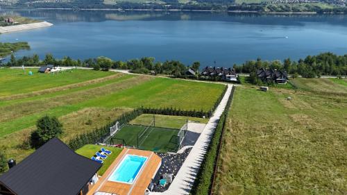 an aerial view of a house with a swimming pool and a lake at Velo Active & Spa in Frydman