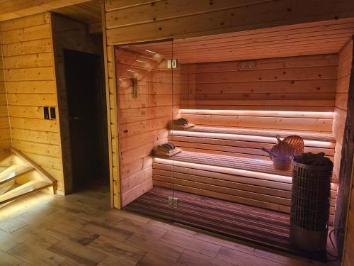 a sauna with a bench in a wooden room at Velo Active & Spa in Frydman