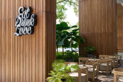 a restaurant with tables and chairs and a sign that reads all future love at The Park Nine Hotel Suvarnabhumi - Free BKK Airport Shuttle in Lat Krabang