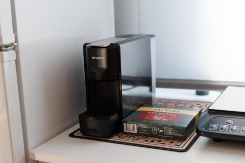 a book and a computer on a shelf next to a printer at Smestaj Dzentlmen in Soko Banja