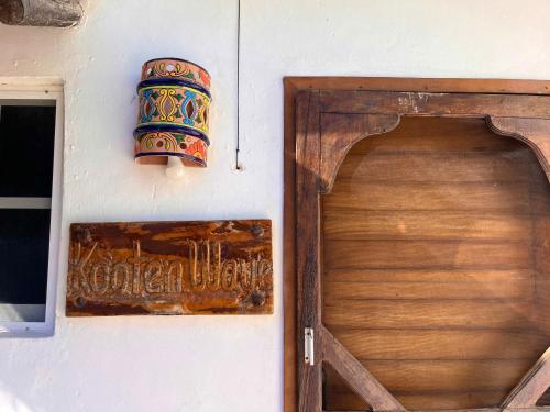 a wooden door and a sign on a wall at Beachfront House with Terrace & Bar, AC, 6 Max in Chuburná