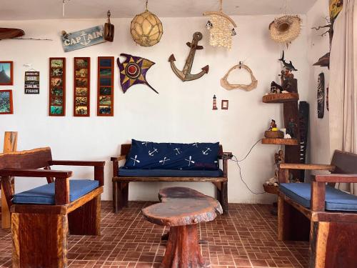 a room with a bench and other items on the wall at Beachfront House with Terrace & Bar, AC, 6 Max in Chuburná