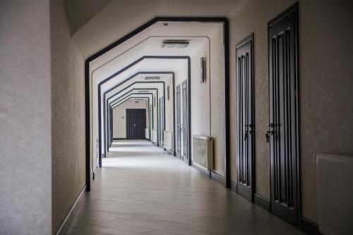 a hallway with a row of doors in a building at Chalet in Shypyntsi