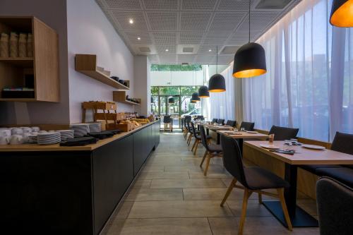 a dining room with long tables and chairs at Nemea Appart Hotel So Cloud Lyon Gare Part-Dieu in Lyon