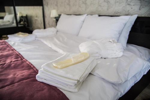 a bed with white towels and a tray on it at Chalet in Shypyntsi