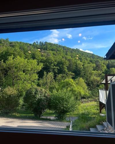 a view of a mountain from a window at Swiss Escape, Chalet with Private Spa & Easy Train Access in Frinvillier