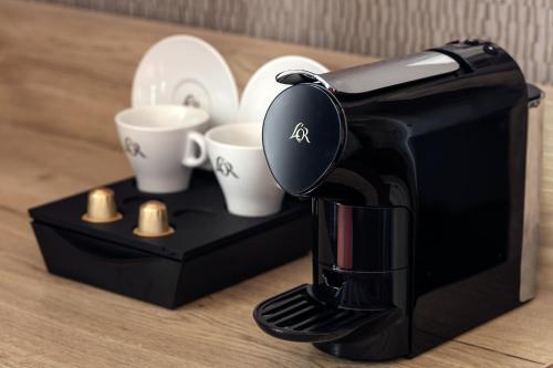 a coffee maker sitting on a counter with coffee cups at Astoria Hotel in Prague