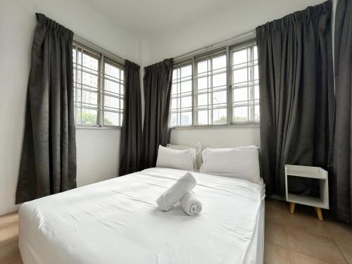 a white bed in a room with windows at Gathering Corner House with 6 Rooms upto 16Pax by Manhattan Group in Kuala Lumpur