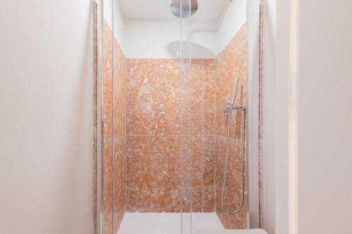 a shower with a glass door in a bathroom at Charming Flat with Patio Lisbon in Bicas