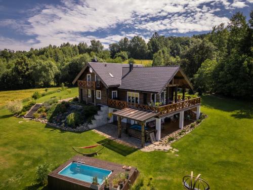 an aerial view of a house with a swimming pool at CHATA POD PRZEHYBĄ in Stary Sącz