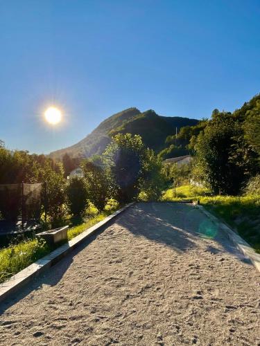 an empty road with the sun in the sky at Swiss Escape, Chalet with Private Spa & Easy Train Access in Frinvillier