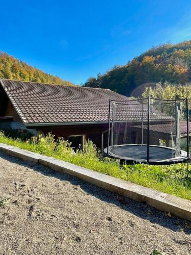 a basketball hoop in front of a house at Swiss Escape, Chalet with Private Spa & Easy Train Access in Frinvillier