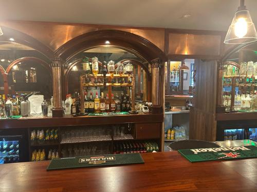 a bar with a lot of bottles of alcohol at Dalys Inn in Donore