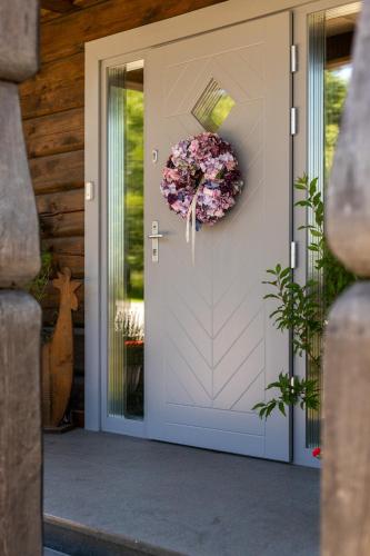 a door to a house with a wreath on it at CHATA POD PRZEHYBĄ in Stary Sącz