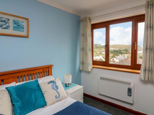 a bedroom with a bed and a window at Surf View in Kingsbridge