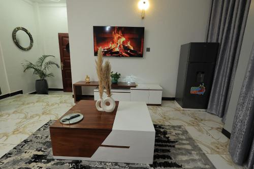 a living room with a fire in the wall at The Nest Kampala in Katale