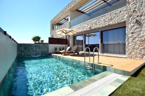 a swimming pool in the backyard of a house at Villa 101 Rhodes in Ixia