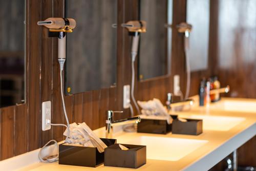 a row of sinks in a public restroom at Okayama International Hotel in Okayama