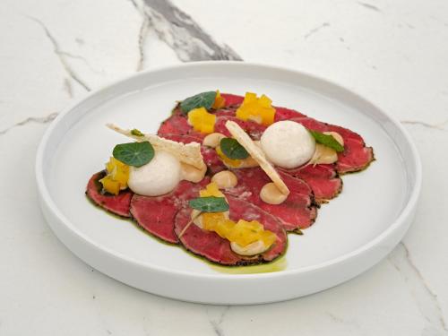 a plate of food on a white plate at Aegean Melathron Thalasso Spa Hotel in Kallithea Halkidikis