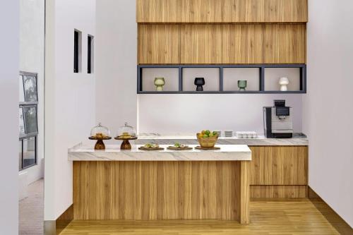a kitchen with wooden cabinets and a counter top at Fairfield by Marriott Kuala Besut in Kuala Besut