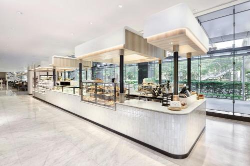 a food court in a building with windows at Le Meridien Taipei in Taipei