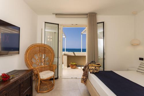 a bedroom with a bed and a balcony with the ocean at AUREA collection SEA VIEW in Cefalù
