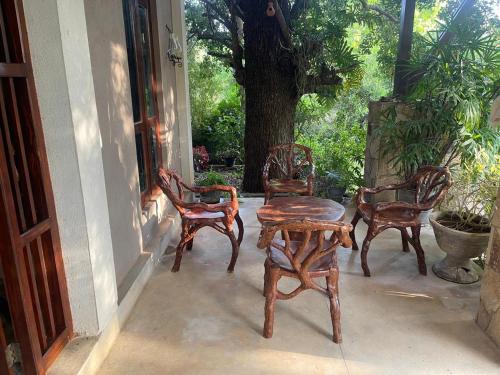 a group of chairs and a table on a porch at Vanaro Resort in Yala
