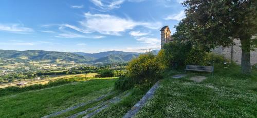 a bench sitting on top of a grassy hill at Casa Nonna Maria in Petrella Guidi