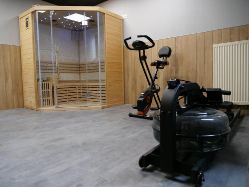 a gym with a treadmill and a exercise bike at Hotel de la Gare in Saint-Mihiel