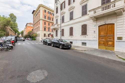 a street with cars parked on the side of a building at FaMa - Mecenate 3BR & 2BA in Rome