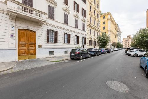 an empty street with cars parked on the side of a building at FaMa - Mecenate 3BR & 2BA in Rome