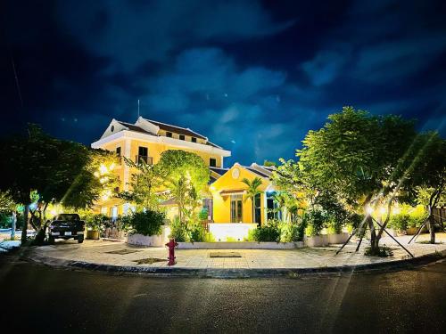 a house with a fire hydrant in front of a street at Laa House in Hoi An
