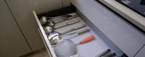 a drawer filled with utensils in a kitchen at Trendy1BR+smart kitchen +Living room+1.5 toilets in Mumbai