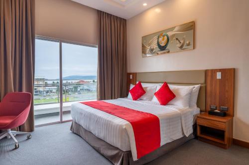 a hotel room with a bed and a large window at Best Western Plus Hotel Subic in Olongapo