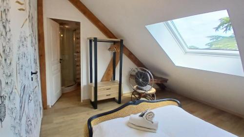 a attic room with a window and a bed at la bicyclette rouge by les étapes chartraines in Chartres