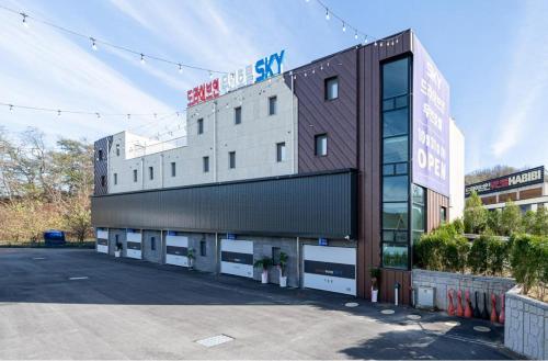 a building with a parking lot in front of it at Pocheon Sky Drive In Hotel in Pocheon
