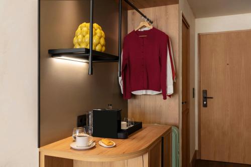 a room with a counter with a microwave and a shirt hanginghiba at Salitre Hotel, Sonder by Marriott Bonvoy in Málaga