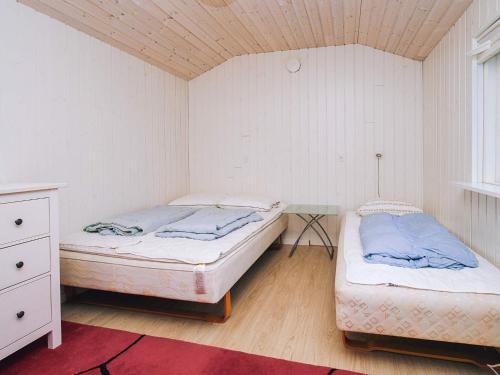 a bedroom with two beds and a table in it at 6 person holiday home in Slagelse in Slagelse