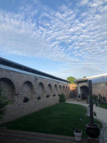 a brick building with a courtyard with a grass yard at Vila BOHI in Lednice