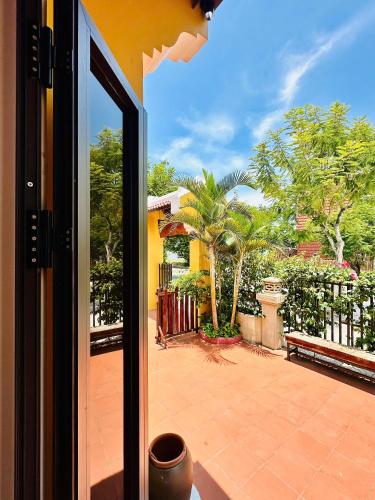 a view of a patio from a glass door at Laa House in Hoi An