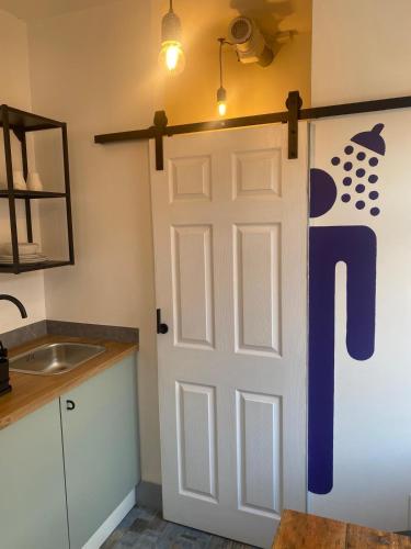 a bathroom with a door with a toilet sign on it at 2 Newcastle Street in Crewe