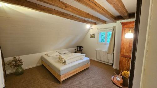 a bedroom with a bed in a room at Grande maison de campagne aux portes du Perche à 20 min de Chartres in Friaize