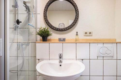 a bathroom with a sink and a mirror at Ferienhaus Rebsteige in Ihringen