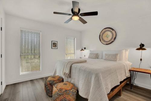 a bedroom with a bed and a ceiling fan at Wanderlust #4 | Hot Tub | Shared Outdoor Space in Fredericksburg